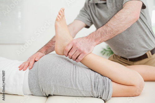 Close-up of a woman lying while being stretched