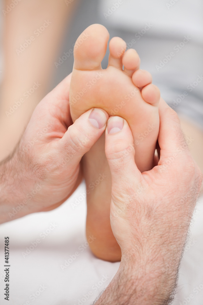 Hands massaging a foot Hands massaging a foot