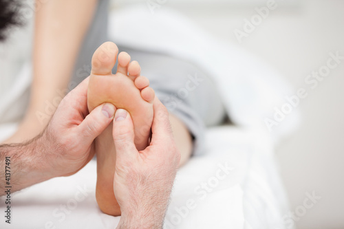 Foot being massaged on a medical table