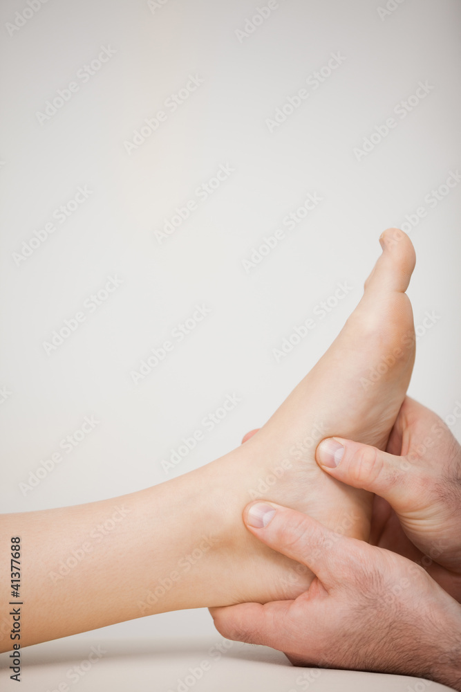 Two thumbs being placed on the side of a foot Two thumbs being placed on the side of a foot