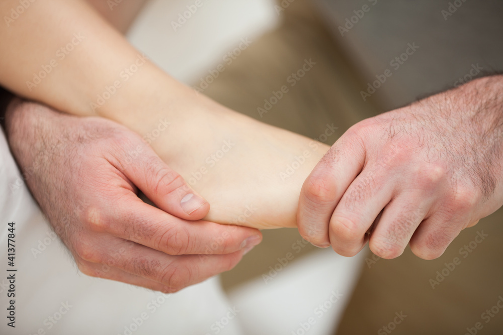 Foot being stretched by a physiotherapist Foot being stretched by a physiotherapist
