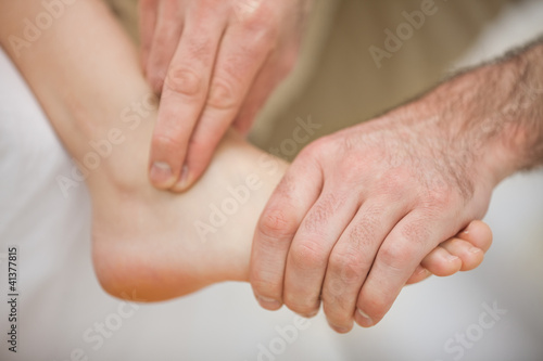 Physiotherapist massaging a barefoot