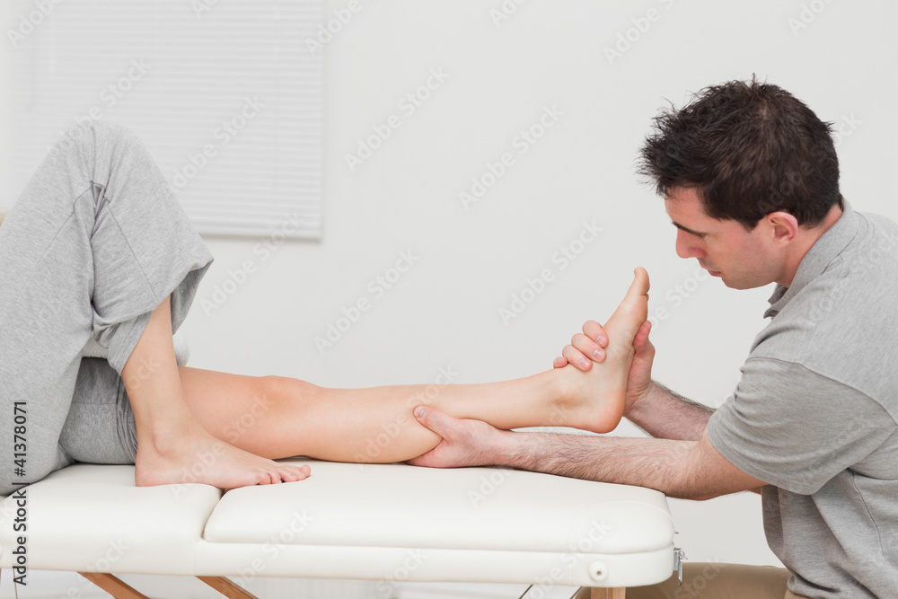 Calf of a patient being massaged by a physiotherapist Calf of a patient being massaged by a physiotherapist