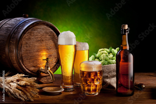 Beer barrel with beer glasses on a wooden table.