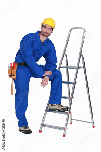 Handyman stood casually with ladder