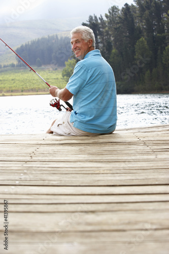 Senior man fishing on jetty