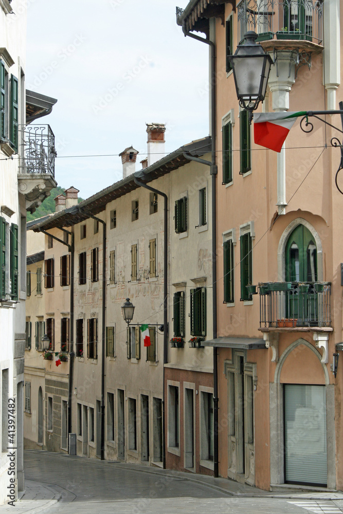 narrow country road in Friuli Gemona with Italian flags