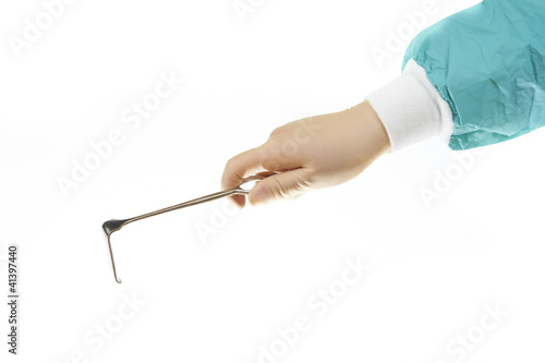 Surgical retractor held by surgeons hand isolated on white