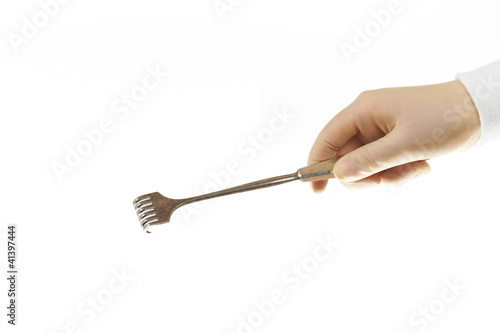 Tableau sur toile Surgical retractor held by sugeons hand isolated on white