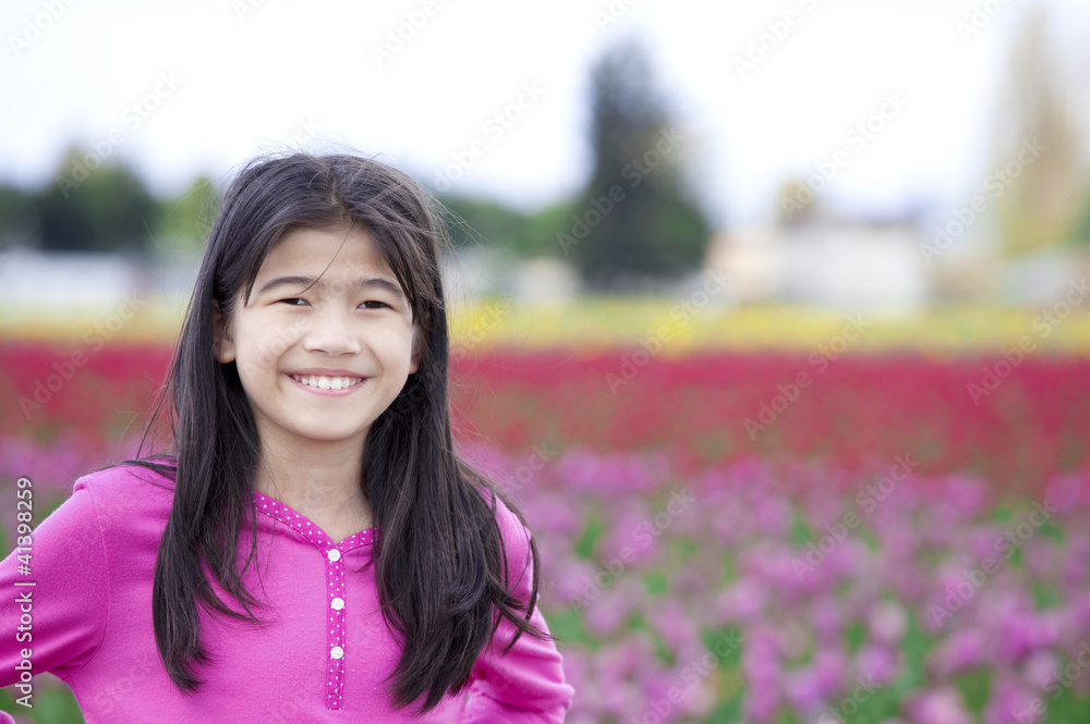 Ten year old girl smiling in front of tulip fields Ten year old girl smiling in front of tulip fields