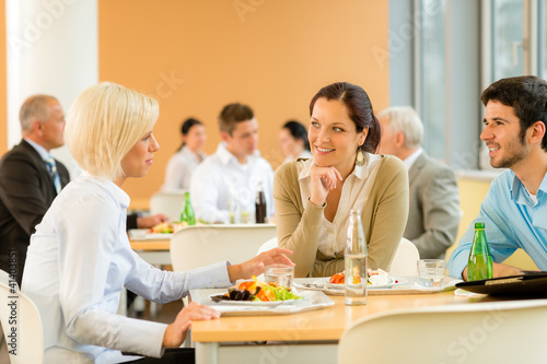 Cafeteria lunch young business people eat salad