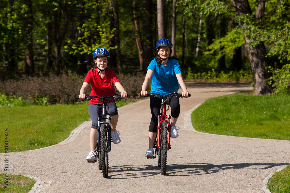 Fototapeta premium Girls riding bikes