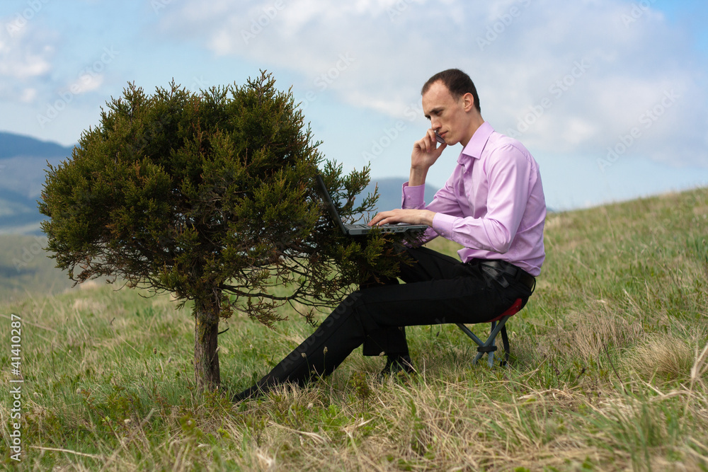 man with telephone and computer on tree man with telephone and computer on tree