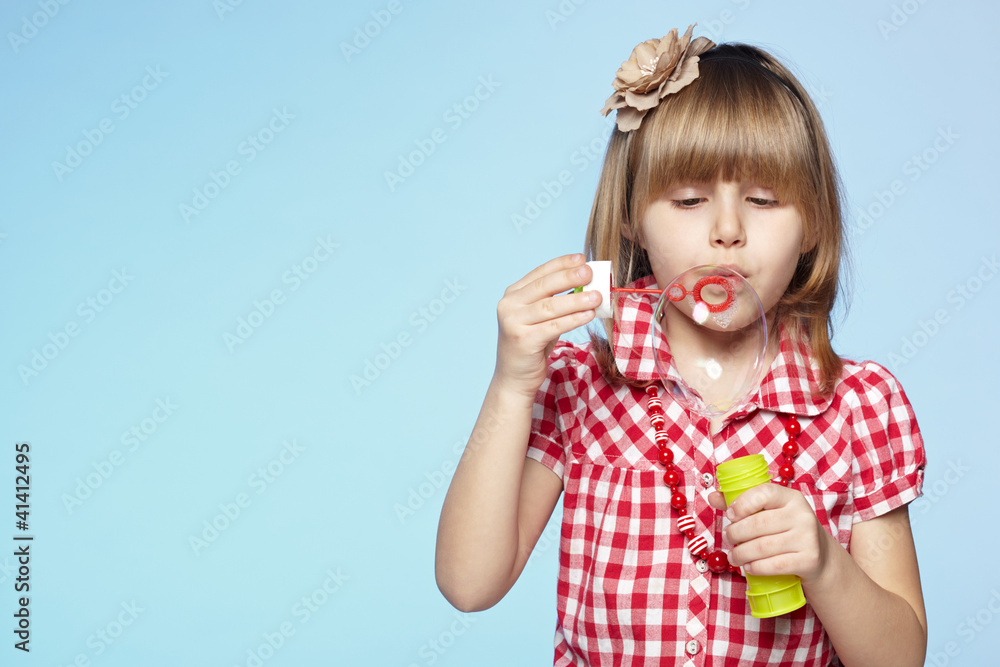 Portrait of little girl blowing soap bubbles Portrait of little girl blowing soap bubbles