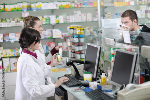 pharmacist suggesting medical drug in pharmacy drugstore