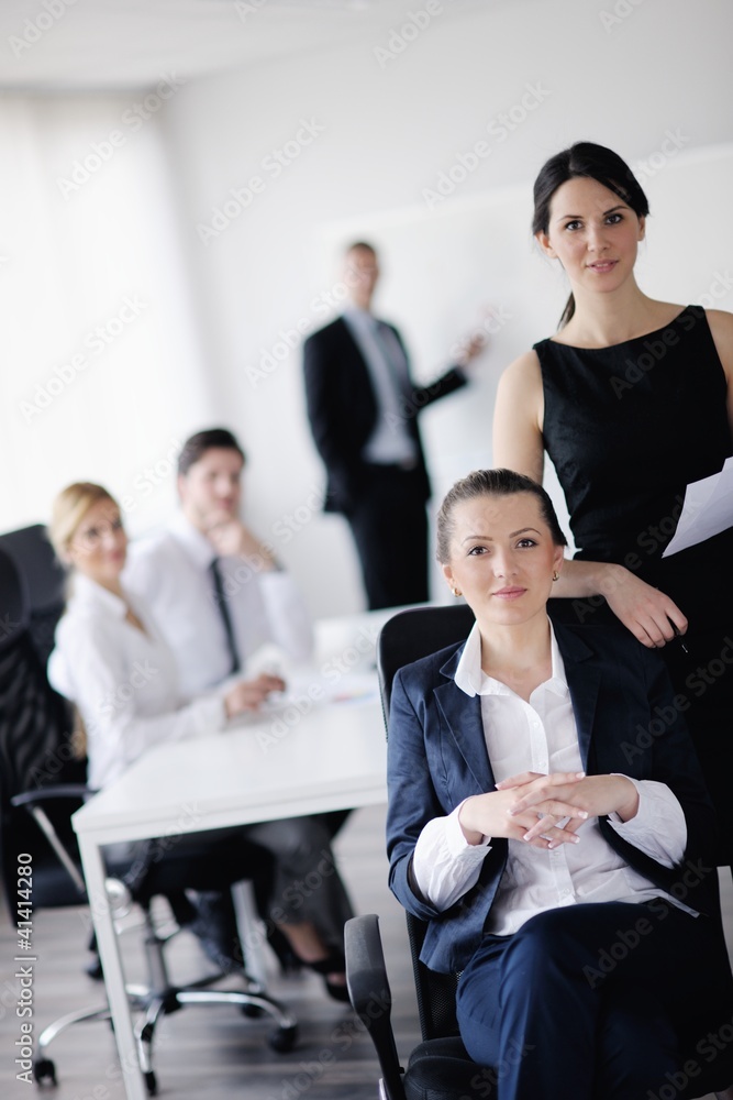 business woman with her staff in background business woman with her staff in background