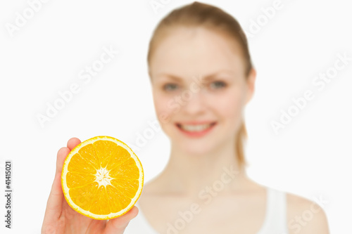 Smiling woman holding an orange