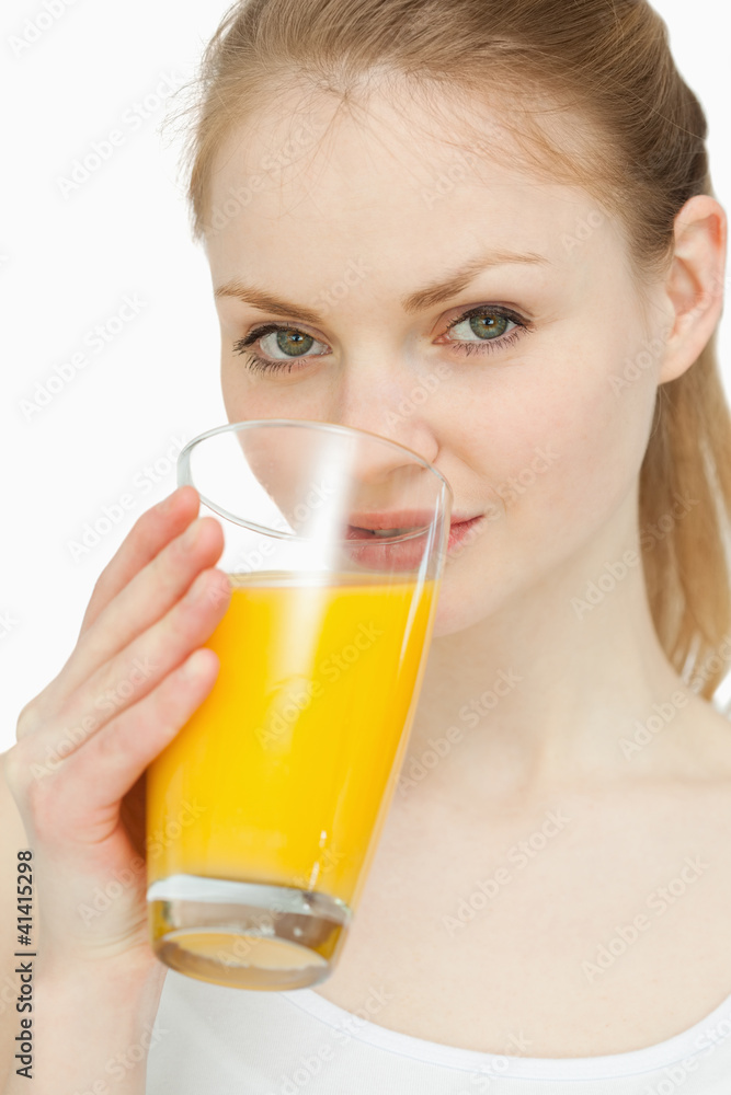 Woman drinking a glass of orange juice Woman drinking a glass of orange juice