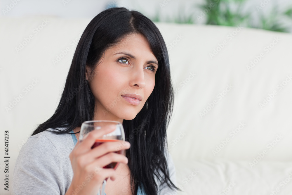 Woman holding a glass full of wine Woman holding a glass full of wine