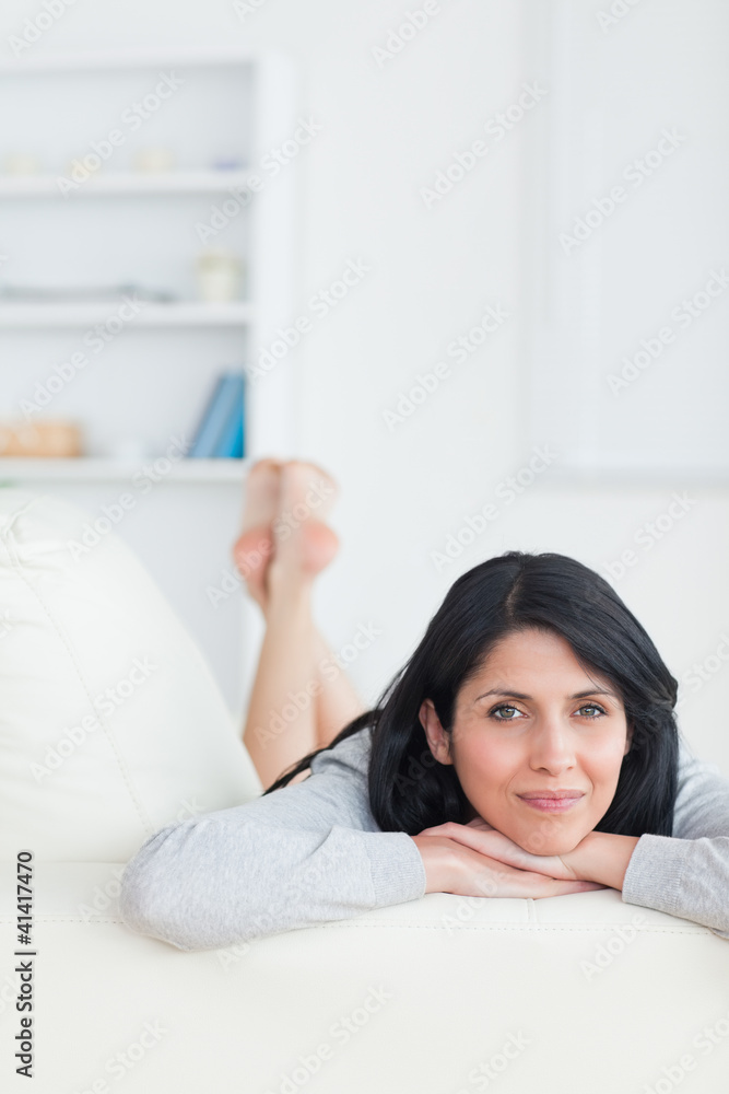Woman with her head resting on her crossed arms Woman with her head resting on her crossed arms