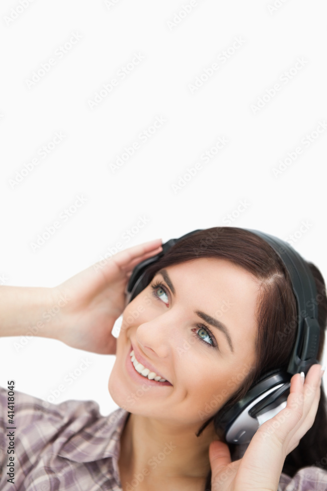 Woman enjoying music with headphones while looking up Woman enjoying music with headphones while looking up