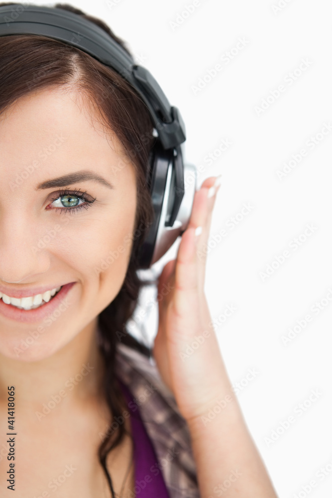 Blue eyed brunette smiling while wearing headphones Blue eyed brunette smiling while wearing headphones