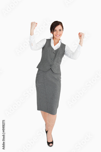 Woman in grey suit walking the fists raised
