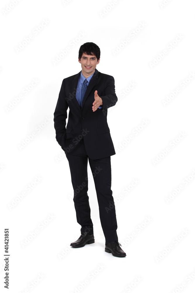 Businessman holding his hand out for a handshake Businessman holding his hand out for a handshake