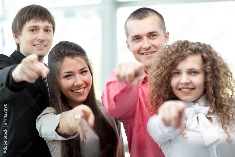 Obraz premium Happy diverse group of executives all pointing at you