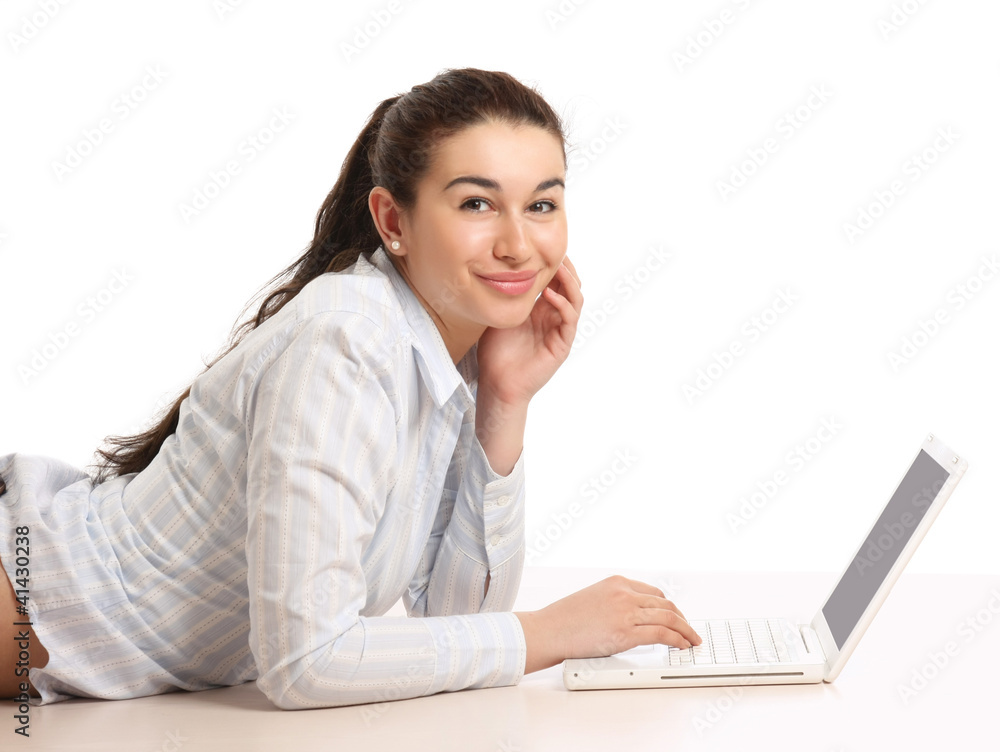 A young girl with a laptop lying on the floor, side-view A young girl with a laptop lying on the floor, side-view