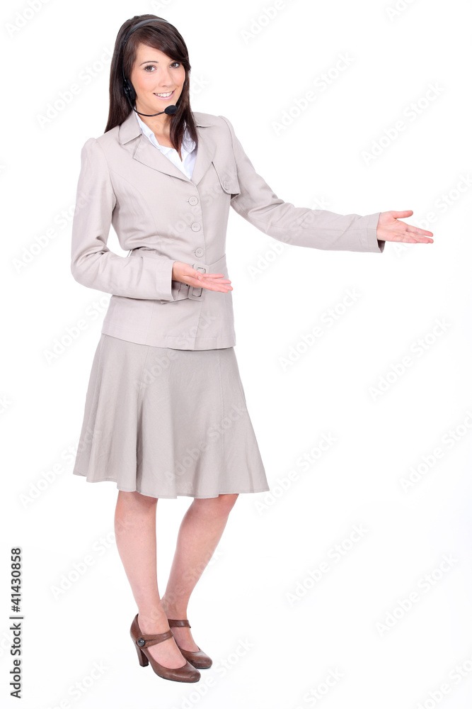 Full length studio shot of a woman with a headset Full length studio shot of a woman with a headset