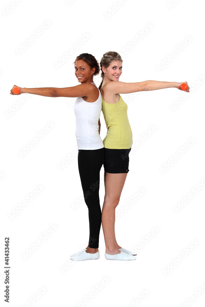 two women doing exercises with dumbbells