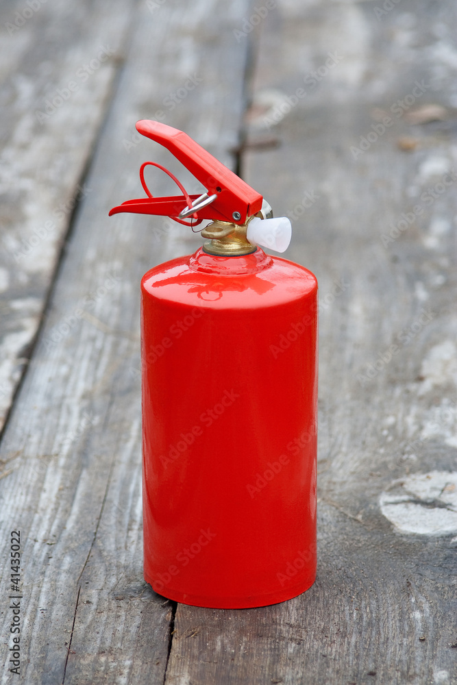 Extinguisher on the wooden sidewalk