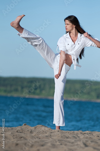 Athletic woman performing a kick