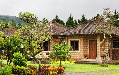 Some small houses in an environment tropical plants