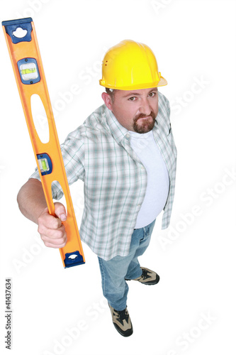 Builder brandishing a spirit level