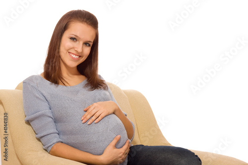 Portrait of a young pregnant girl on a light background