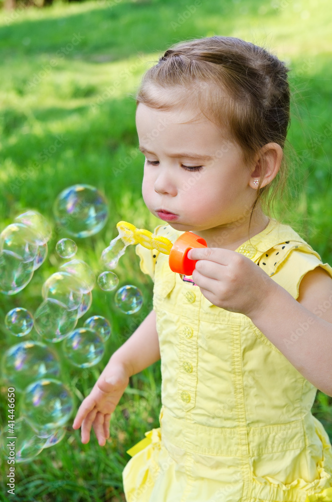 Portrait of little girl blowing soap bubbles Portrait of little girl blowing soap bubbles