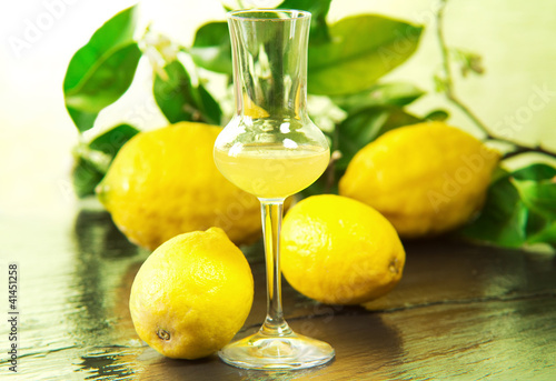 limoncello glass with fresh lemons photo