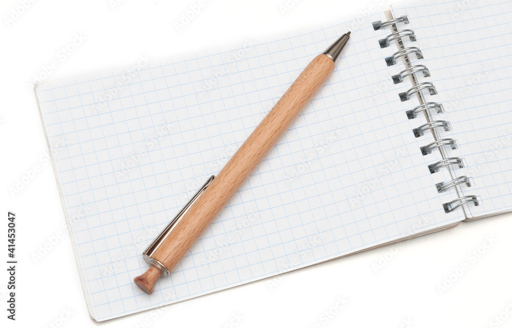 wooden ball pen and a notebook on a white background wooden ball pen and a notebook on a white background
