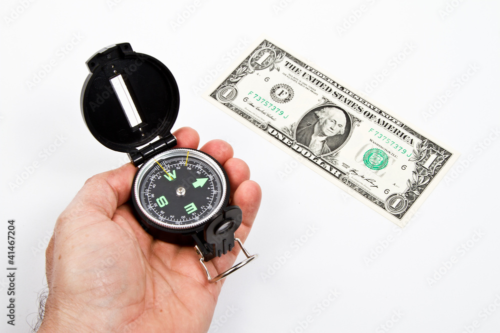 Isolated compass and 1 dollar note over withe table Isolated compass and 1 dollar note over withe table