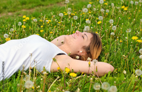 Spring: young, pretty woman relaxing in meadow with dandelions 2 photo