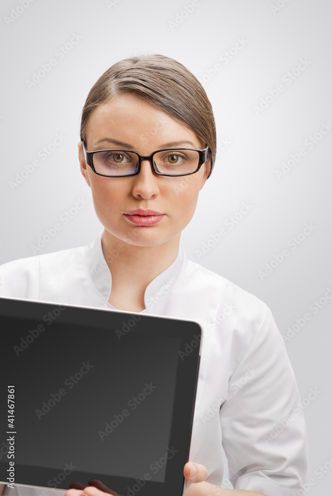 Young woman doctor in white coat holding digital tablet pc Young woman doctor in white coat holding digital tablet pc