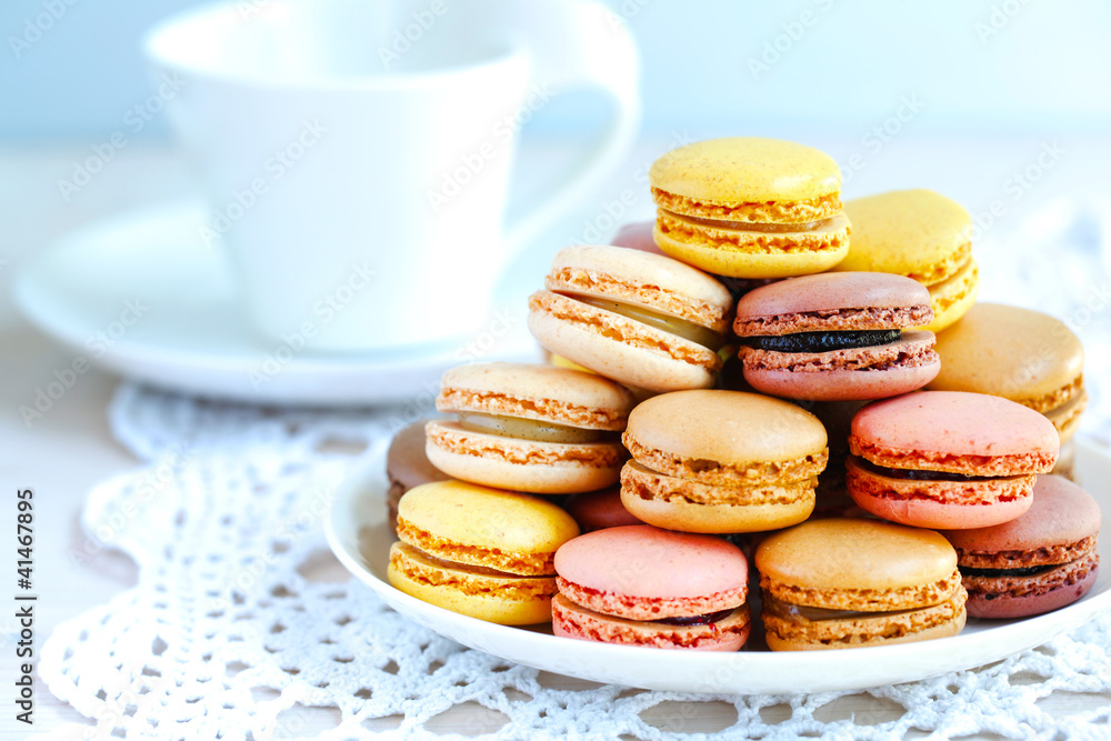 Tray full of colorful macaroons on a lace knit napkin
