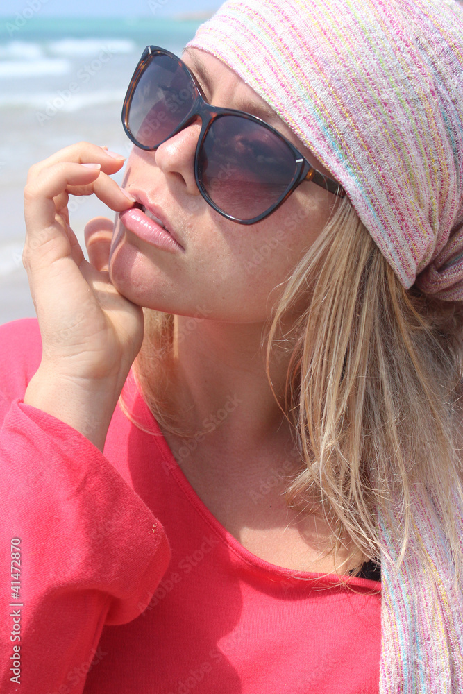 Naklejka premium A beautiful blonde at the beach
