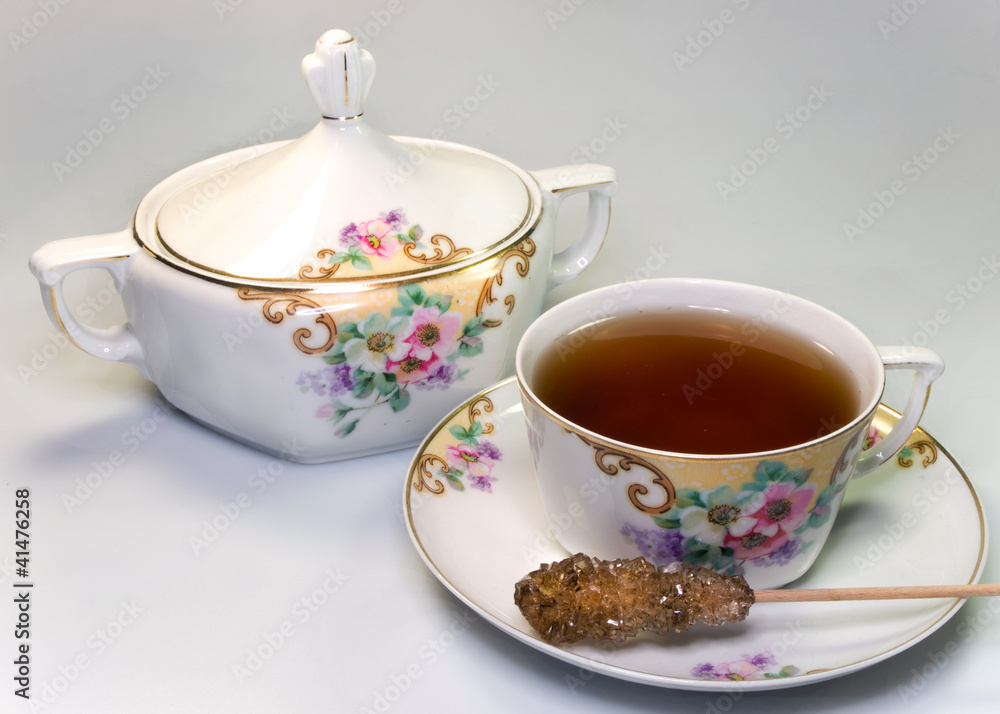 Antique crockery with tea and sugar stick Antique crockery with tea and sugar stick