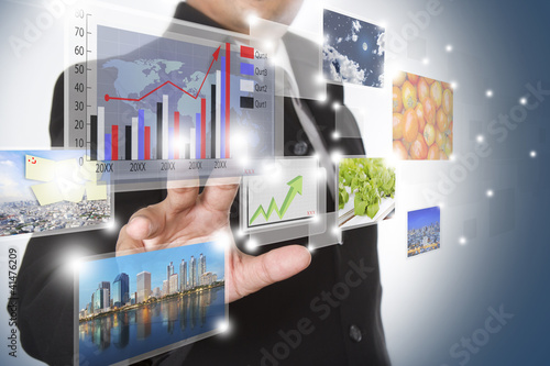 businessman pushing on a touch screen