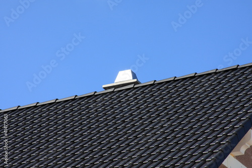 schwarzes Dach mit Schornstein
