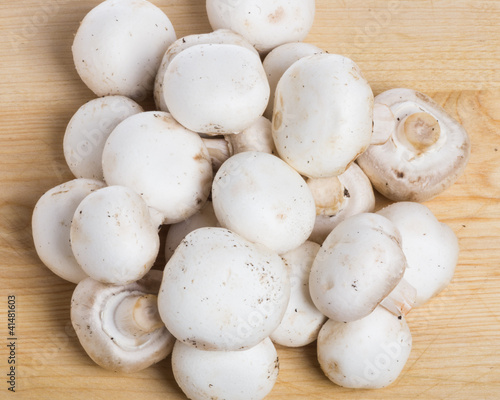 Group of button mushrooms on cutting board
