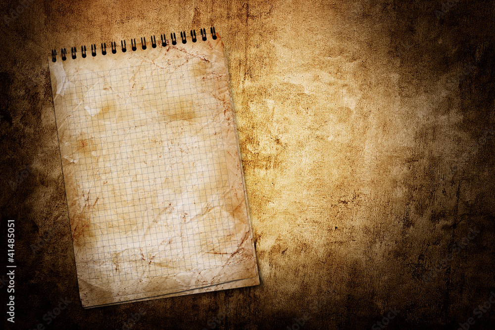 Naklejka premium old used notebook on grunge background